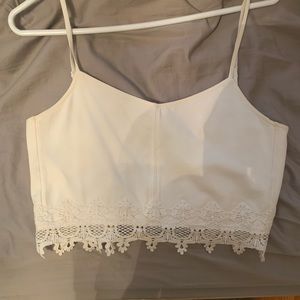 White crop top with lace embroidery at bottom